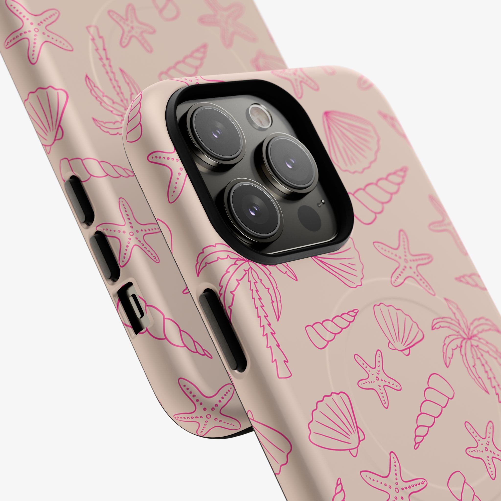 Close-up of a phone with a Shoreline | Signature Series Phone Case (MagSafe) featuring a subtle beige background with pink marine-themed outlines including starfish, seashells, and palm trees.