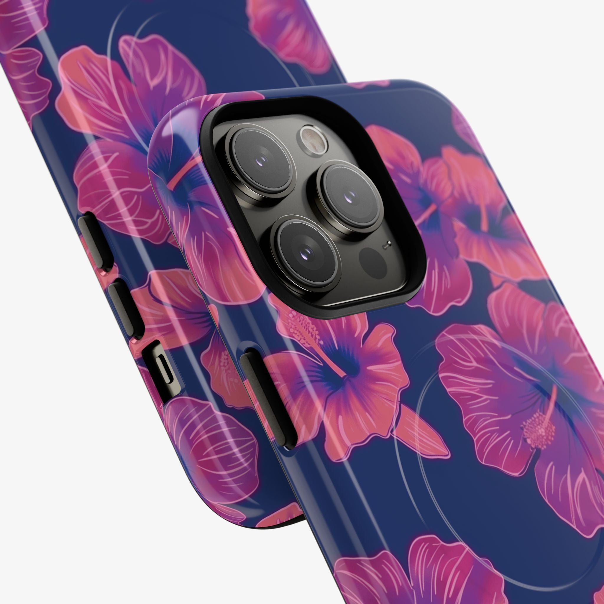 Close-up of a stylish phone case featuring a vibrant pink floral pattern on a dark blue background, showcasing the Maui Mood | Signature Series Phone Case (MagSafe) with precise camera and button cutouts.